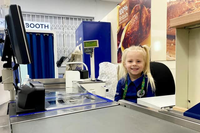 Little Brooke Goacher got the chance to 'work' on the tills at Tesco for a morning. Photo: Jodie Buckley/SWNS