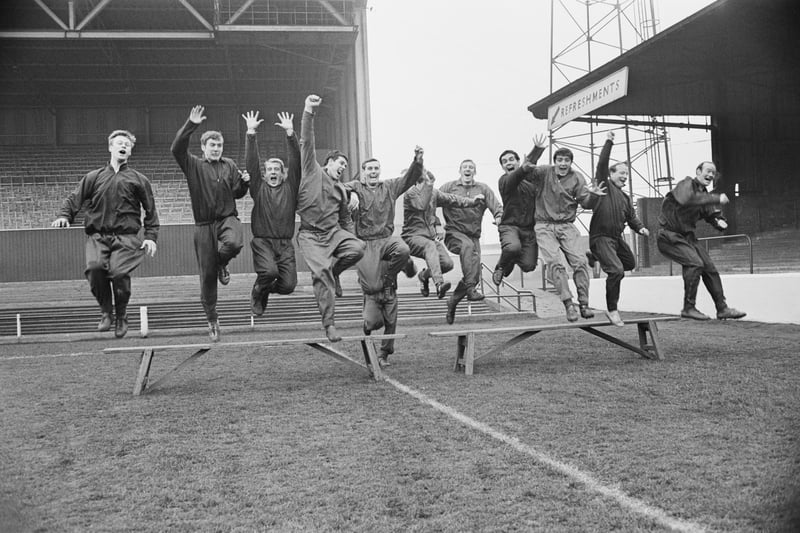 Players of Nottingham Forest are pictured jumping from a bench in training on 14th January 1967.