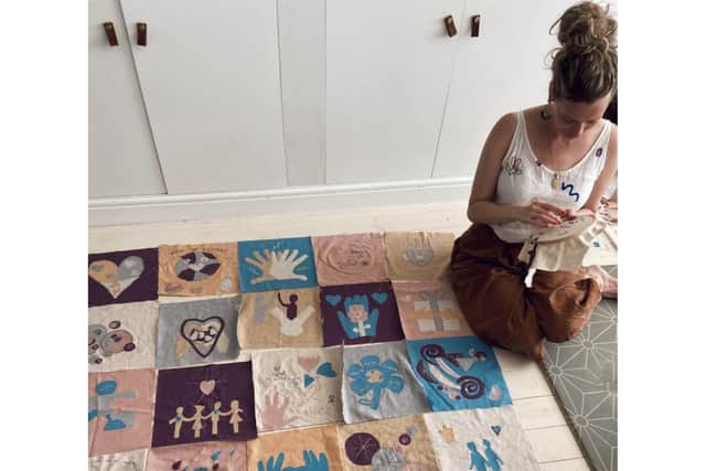 Artist Rebeka Johnston creating the kindness quilt. Photo: Submitted