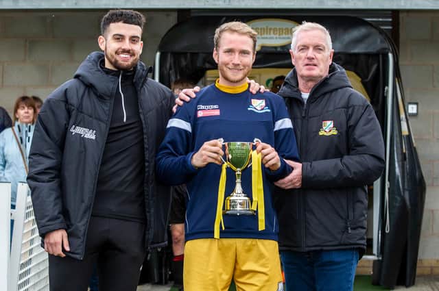 Basford United’s captain Matt Thornhill post-game with cup sponsor William Munroe (left) and Club Vice President Stan Mitchell (IMAGE: Craig Lamont Photography)