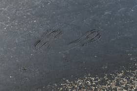 Footprints can be seen on a road where the tarmac started to melt during a record hot day in the UK. Picture: Joe Giddens/PA Radar