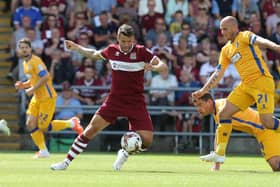 NORTHAMPTON, ENGLAND - AUGUST 09:  Marc Richards of Northampton Town attempts to control the ball watched by Adam Murray #21 and John Dempster of Mansfield Town during the Sky Bet League Two match between Northampton Town and Mansfield Town at Sixfields on August 9, 2014 in Northampton, England.  (Photo by Pete Norton/Getty Images)