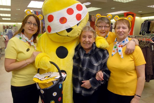 2009: Customer Hazel Stubbs meets Pudsey Bear and staff at Bon Marche in Bulwell.