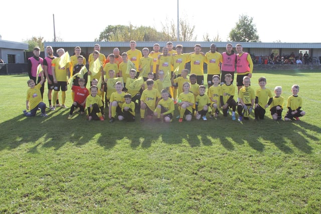 Members of the club's youth team, Hucknall Warriors, with the first-team players before the game.