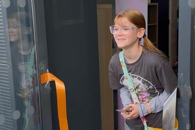 Club member Harper Stevenson cuts the ribbon to officially open Wildkatz Sports Academy's new home. Photo: Submitted