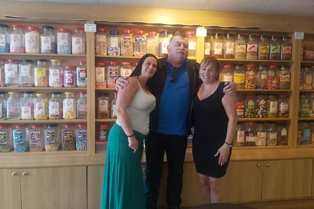 Keith with The Sweet Cafe owners Angelina and Louise and the jars of sweets that helped inspire his stories