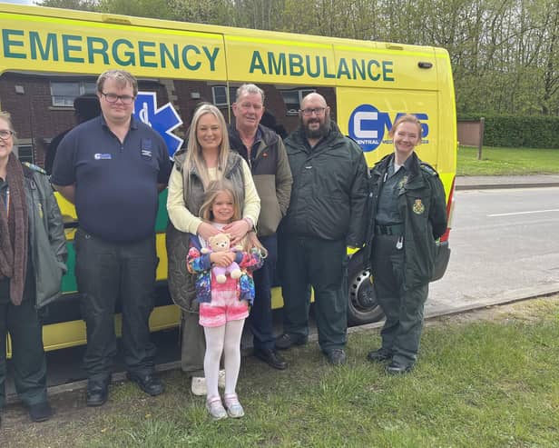 Chris Handley, with daughter April and granddaughter Summer and members of the emergency care team who saved his life. Photo: Submitted