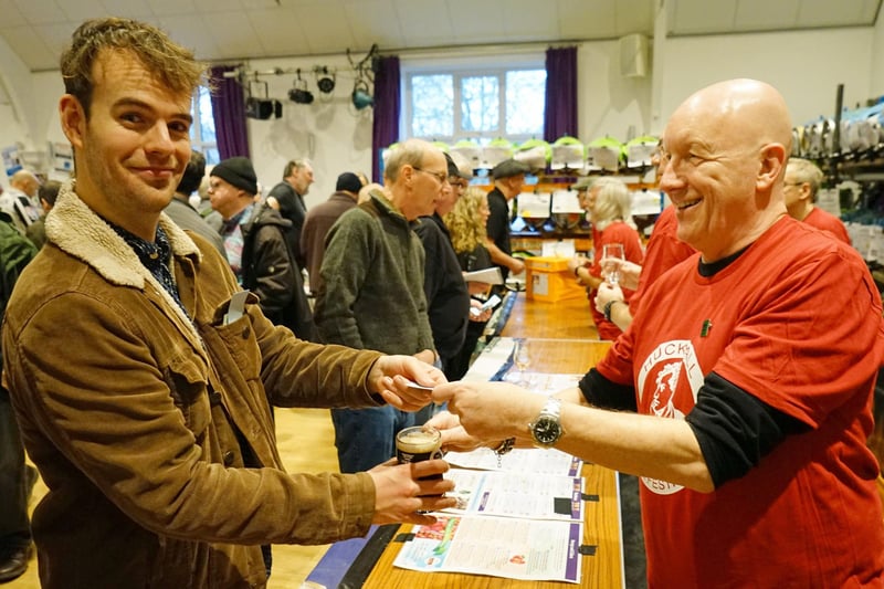 Festivalgoer Lewis Wood is served another new brew by John Blackley