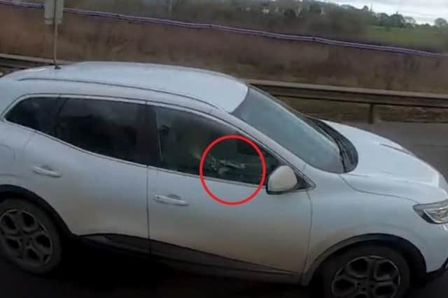 A motorist caught driving one-handed while using her mobile phone along the M40, which links Birmingham and London.