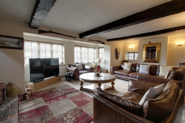 At the heart of the £700,000-plus home is this spacious lounge, made stunning by its exposed stonework and beams to the ceiling. Windows at the front, side and back of the property allow a plentiful amount of natural light.