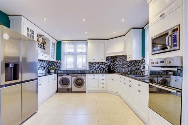 Recessed spotlights and windows to the side and rear brighten up the kitchen no end. Integrated appliances include a double oven, microwave and induction hob with an extractor fan. As you can see, there is also room for an American-style fridge/freezer.