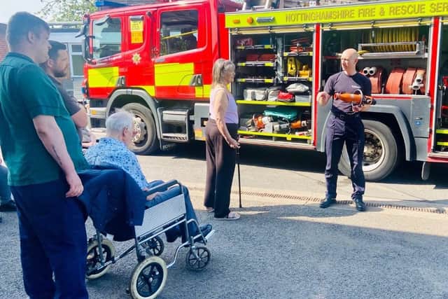Hall Park Care Home staff and residents listen to firefighters.