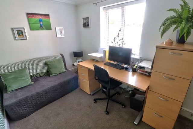 The second bedroom on the ground floor is a versatile space that could be converted into an attractive home office or study. It faces the front of the house and has a carpeted floor.