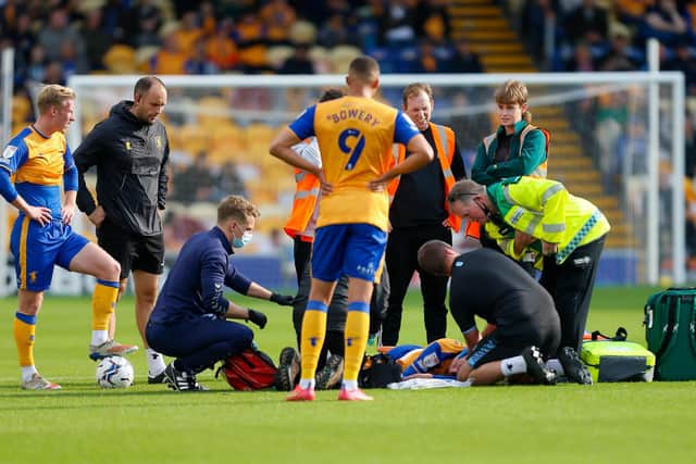 Mansfield Town midfielder George Maris receives treatment on Saturday. Photo by Chris Holloway/The Bigger Picture.media