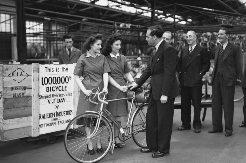 British Labour politician George Strauss the Minister of Supply, chats with two workers from the Raleigh packing department in Nottingham, before the dispatch of the millionth Raleigh bicycle to be shipped overseas since VJ Day, 21st April 1949.