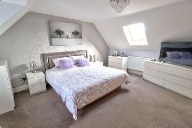 Up to the first floor, where there are two large bedrooms, including this one, which has built-in wardrobes for storage and access to an en suite shower room. There is a uPVC wood-effect window to the front of the house, a Velux window to the rear and a carpeted floor.
