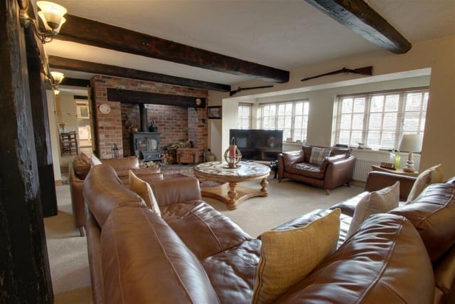 The eyecatching focal point of the lounge is a superb fireplace with a wood-burning stove.