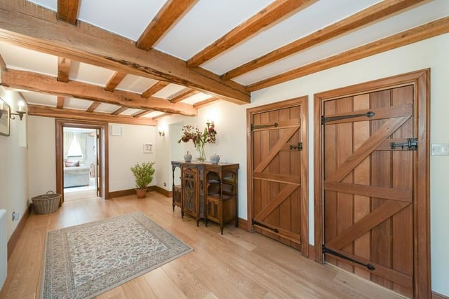 The spacious inner hallway is a wonderful sight, with its exposed beams, oak flooring and characterful doors.