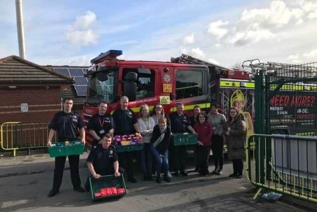 Hucknall firefighters delivering Easter eggs and treats to the Sure Start Centre in the town