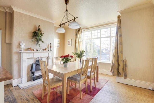 The delightful dining space in the kitchen/diner includes a feature fireplace with a decorative surround, and also a double-glazed box bay window overlooking the front of the house.