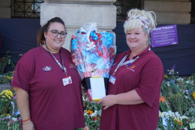 Staff from SSBC with the special handmade paper bouquet for the Queen