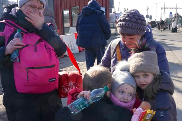 Ukrainian women and children cross the border from Ukraine to Poland (Photo by JANEK SKARZYNSKI/AFP via Getty Images)