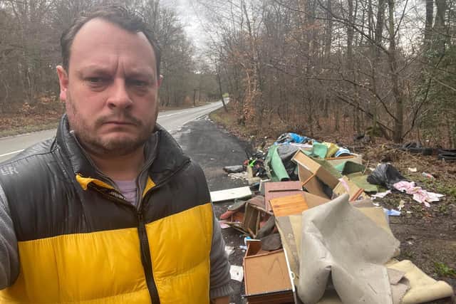Council leader Coun Jason Zadrozny-Bland next to the fly-tipped waste