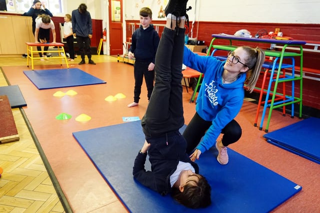 Beth Tweddle Gymnastics at King Edward Primary School. Samantha Scotland schools co-ordinator helps one of the pupils learn a new move.