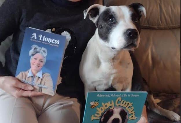Michelle and Tubby Custard with her book A Lioness which she wrote last year. Photo: Submitted