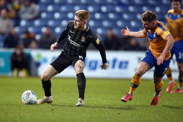 Ryan Watson of Northampton controls the ball watched by Alex MacDonald of Mansfield in 2019.