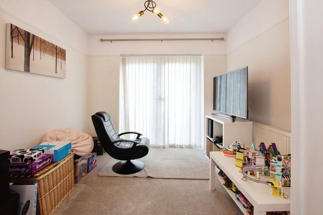 The double doors in the lounge lead to this versatile room, which can be used as a study, home office or snug. Not shown in the picture are French doors that open out on to the rear garden.
