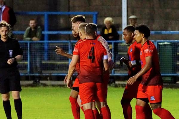 Aaron O'Connor (centre) takes the plaudits as he opens the scoring for Basford United in their 2-0 win at Stalybridge on Tuesday night (IMAGE: Mick Gretton)