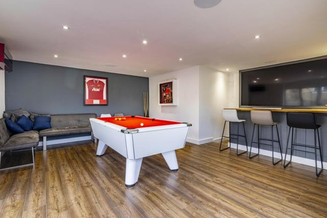 ....and yes here it is, the games room and bar which forms a garden room that used to be the property's detached double garage. A positively palatial haven, it features a full-sized pool table, seating, two sets of bi-folding doors and spotlights.