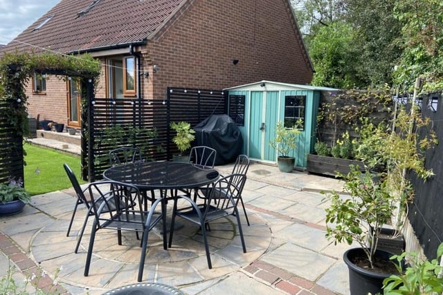 Stroll through the archway at one end of the rear garden and you will discover this enchanting private patio area, which is ideal for relaxing or entertaining friends in the summer.