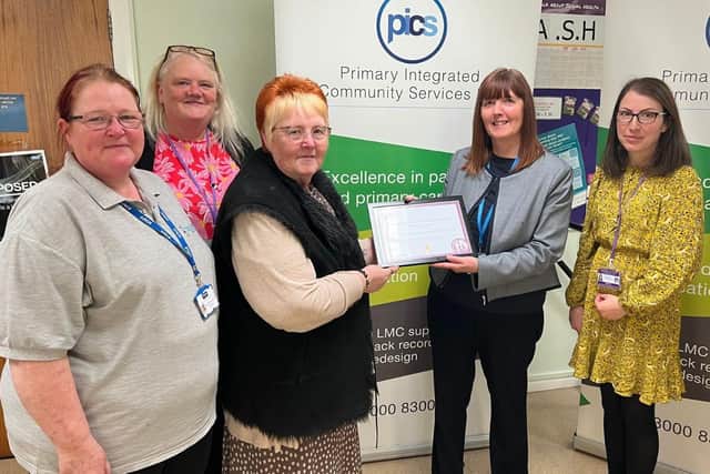 Hucknall resident and carer Marilyn Clifton presents the award to Karen Frankland, managing director of PICS. Photo: Submitted