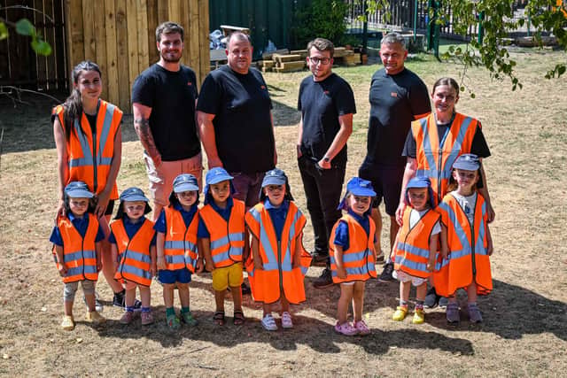 QTS workers with youngsters from Applegarth Nursery on the land the firm has now donated to the nursery