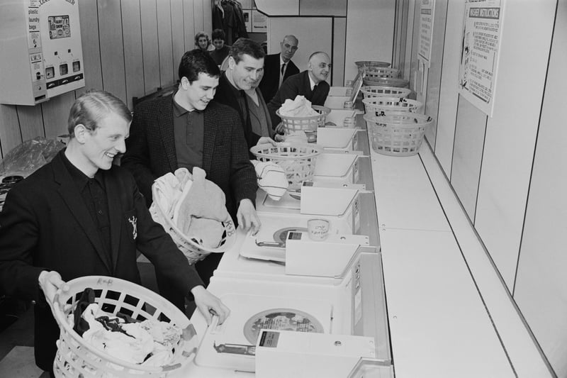Players of Nottingham Forest FC and Irish manager Johnny Carey are pictured doing their laundry at a launderette on 14th January 1967.