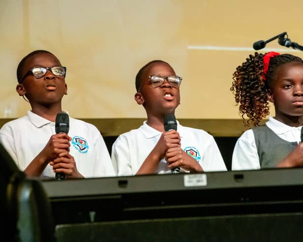 Hucknall Flying High Academy triplets Waimi, Mbetmi and Yimi Fongue spoke to the audience about taking responsibility for our environment. Photo: Lou Brimble