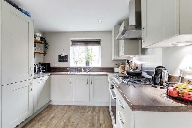 The kitchen features a whole host of integrated appliances, including an oven, gas hob with extractor hood, fridge, freezer, dishwasher and washing machine.