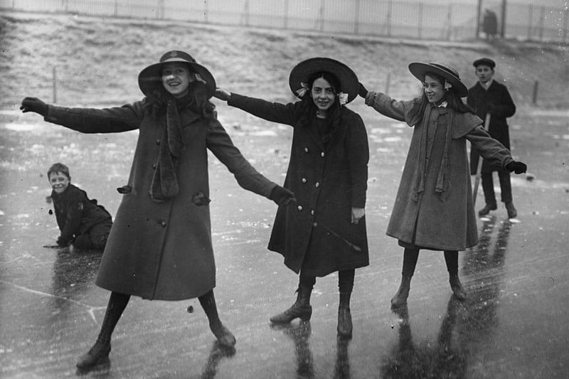 A group of schoolgirls venture out onto a flooded field in Nottingham after a severe freeze on 29th January 1912.