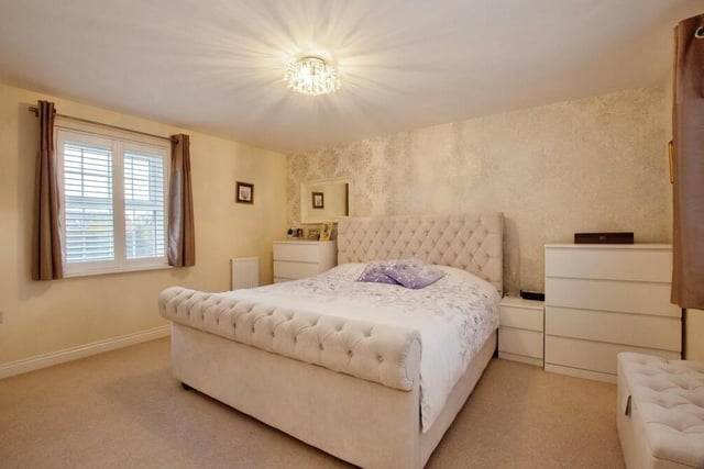 Up to the first floor now of the Peregrine Road property, where there are four double bedrooms, including this one. It has a fantastic walk-in dressing area with a range of fitted wardrobes.