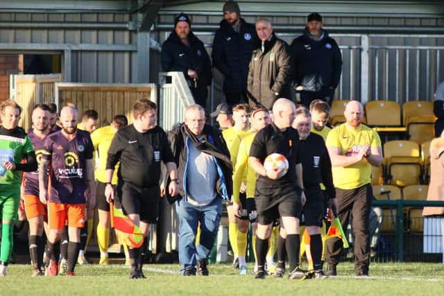 Hucknall Town v Harrowby (purple), the teams come out for the first match at the new ground.