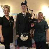 Photo is of the bagpiper Daniel Hanlon with Hall Parks manager Jodie  Rakhra and carer Fay Buck