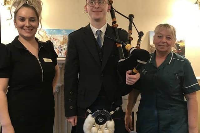 Photo is of the bagpiper Daniel Hanlon with Hall Parks manager Jodie  Rakhra and carer Fay Buck