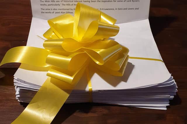 The petition document, wrapped in a yellow ribbon that has become a symbol of the campaign