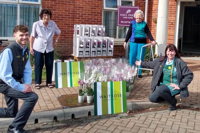 Ryan Spencer and Lynn Fleet from Waitrose present the orchids with Hall Park residents ambassadors Nina Sansom and Marjorie Garlick