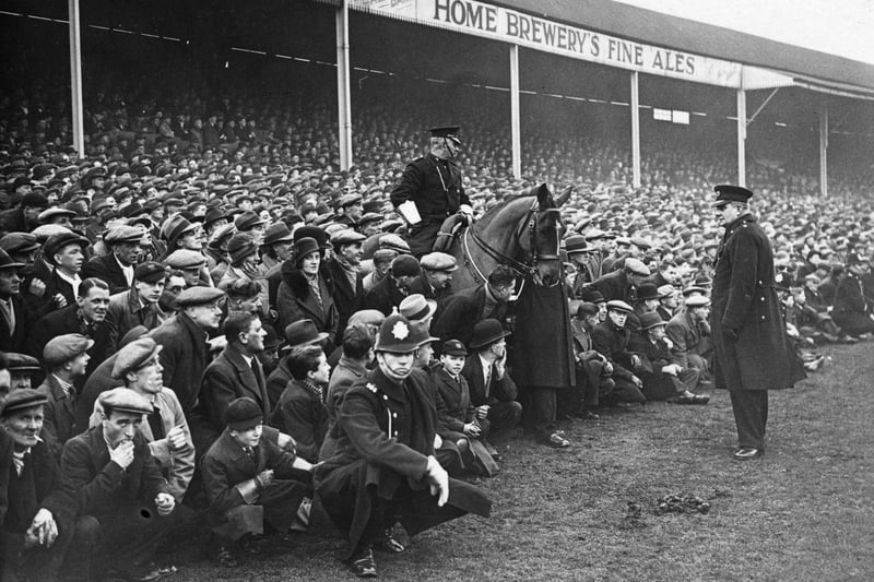 31st January 1934:  A mounted policeman amongst the crowd overflowing onto the pitch for Nottingham Forest's FA Cup tie replay against Chelsea.