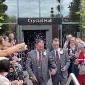 The happy couple are showered with confetti after getting married.