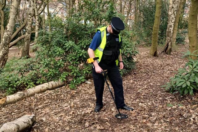 PCSO Chris Lowe conducting the weapons sweep with a metal detector on the day
