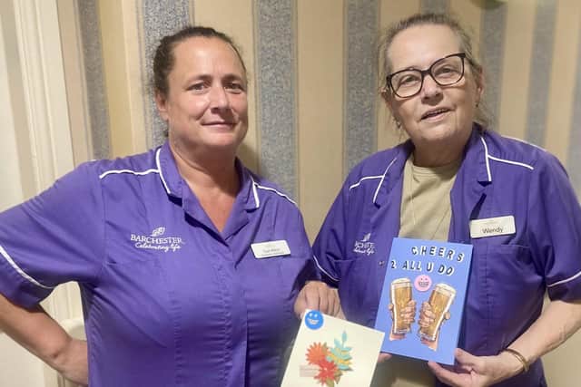 Two Hall Park housekeepers with thank you cards made by residents. (Photo by: Hall Park Care Home)